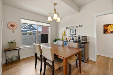 Dining room featuring light wood-style floors and a chandelier