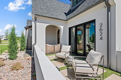 The gated front patio offers a quiet spot to sit and unwind, tucked just outside the office with easy access through French doors. It’s a great place for morning coffee, casual conversation, or simply watching the neighborhood go by.