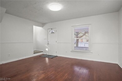 The living room with refinished wood floors