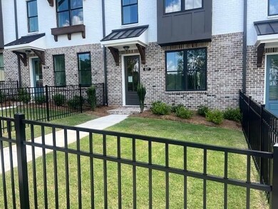 Property entrance with brick siding and a standing seam roof