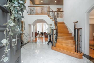 Foyer with crown molding, a high ceiling, and ligh