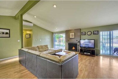 The living room has lots of windows and a slider f