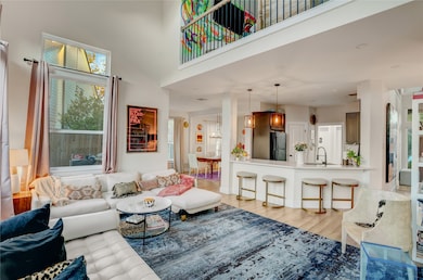 A panoramic view of the main living space highlights the airy layout and flexible furniture zones. The neutral color palette complements natural light from multiple exposures. Every corner feels bright, open, and inviting.