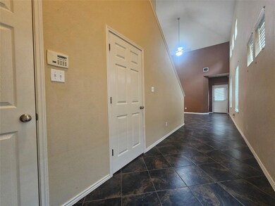 Entryway with high vaulted ceiling and stone fini