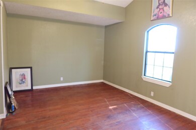 Unfurnished room with dark hardwood / wood-style f