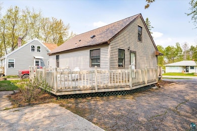 Rear view of property with a deck and roof with shingles