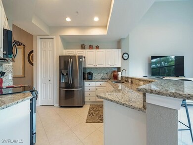 Kitchen with white cabinetry, kitchen peninsula, s