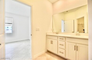 Bathroom featuring double vanity, tile patterned f