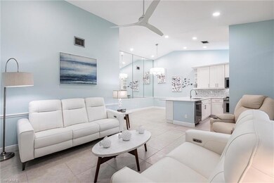 Living room featuring a ceiling fan, baseboards, recessed lighting, light tile patterned floors, and high vaulted ceiling