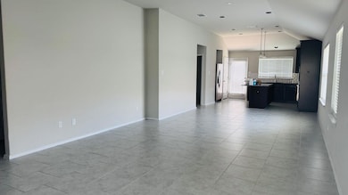 Unfurnished living room featuring vaulted ceiling