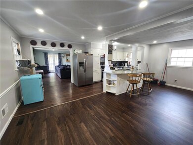Kitchen with white cabinetry, kitchen peninsula, d