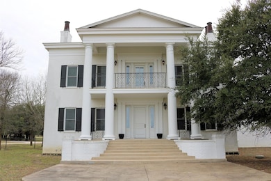 Neoclassical / greek revival house featuring a ba