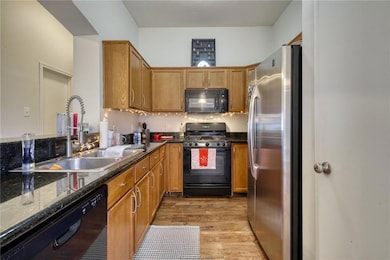 Kitchen featuring light wood-style flooring, a sin