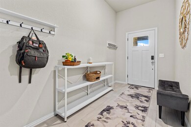 Entryway featuring wood finish floors and baseboards