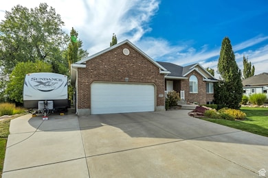 View of front of property with driveway, brick siding, and a garage