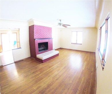 A welcoming woodburning fireplace provides an attr
