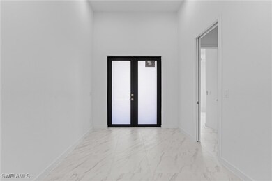 Hall featuring baseboards and marble finish floor
