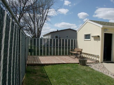 Fenced back yard w/wood patio