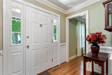 Foyer with picture framing and chair rail detailin