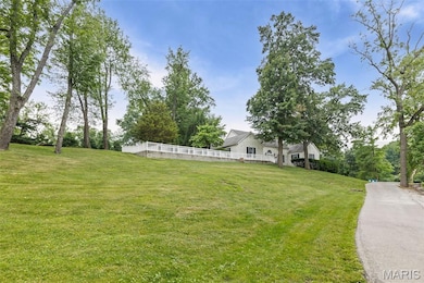 View of side of property with a yard, a chimney, and stucco siding