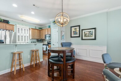 Dining space featuring a chandelier, dark wood finished floors, visible vents, and ornamental molding