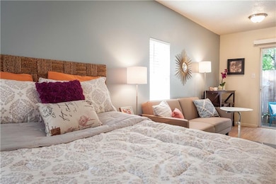 Bedroom with wood finished floors and baseboards