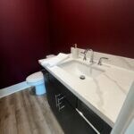 Bathroom with vanity, toilet, and wood-type floori