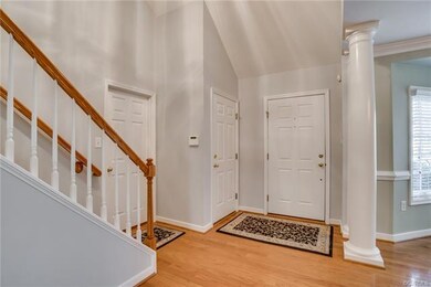 Welcoming 2-story foyer with hardwood flooring.