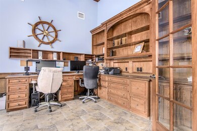 Study showing built-ins and knee-hole slots for partners desk.