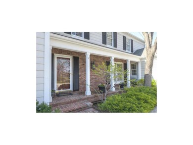 The beautiful brick covered front porch greets you