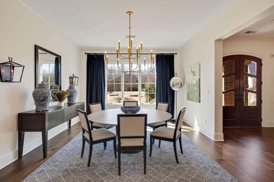 Dining area with crown molding, arched walkways, d