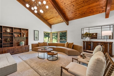 Living area featuring high vaulted ceiling, light