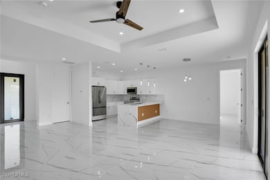 Kitchen featuring pendant lighting, ceiling fan, a