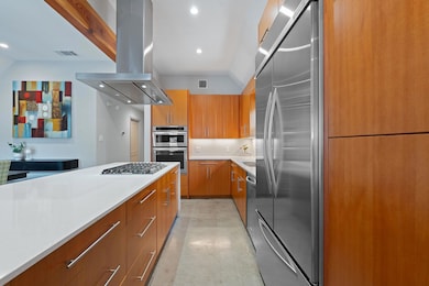 Kitchen with island exhaust hood, concrete floors