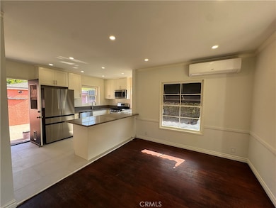 Just add bar stools at kitchen counter