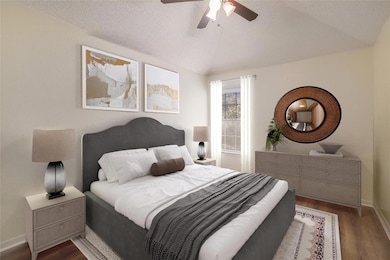Bedroom featuring dark wood-style floors, vaulted