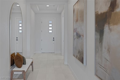Foyer featuring a tray ceiling, light tile pattern