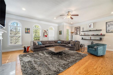 Living area featuring crown molding, wood finished
