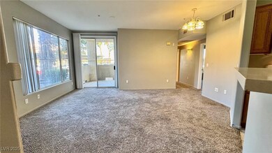 Unfurnished living room with a chandelier and ligh