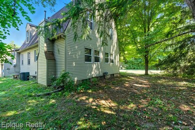 View of home's exterior with a chimney and roof with shingles