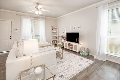 Living room with baseboards, wood finished floors,