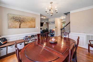 Dining area with a chandelier, ornamental molding,