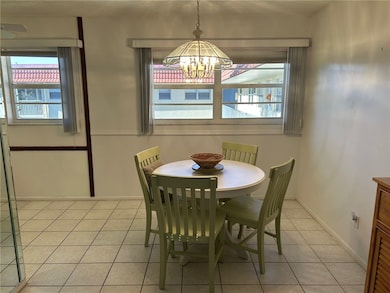 Dining area with light tile patterned floors and baseboards