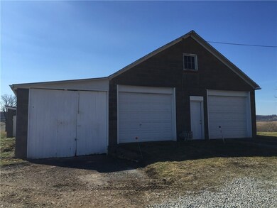 The three car garage with attached workshop.