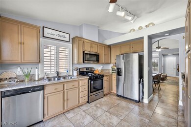 Kitchen featuring arched walkways, stainless steel
