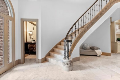 Stairs with a towering ceiling and tile patterned flooring