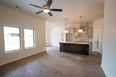 Kitchen with backsplash, premium range hood, ceili