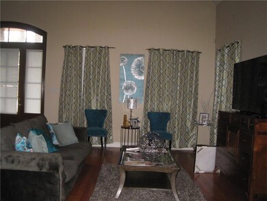Large great room with wood floors and open to dini