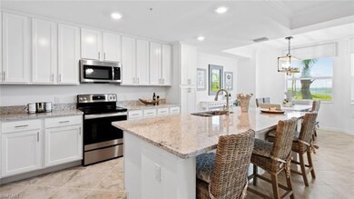Kitchen featuring sink, white cabinets, appliances
