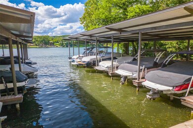 Dock area featuring boat lift and a water view